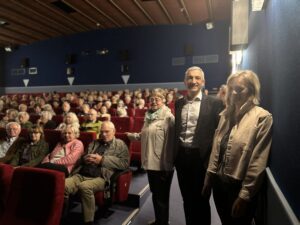 Unser Bild zeigt (stehend v.re.) Doris Werner, Landrat Dr. Ronny Raith und die Kreisseniorenbeauftragte Christine Kreuzer vor den gut befüllten Sitzen im Zwieseler Lichtspielhaus. Foto: Heiko Langer / Landratsamt Regen